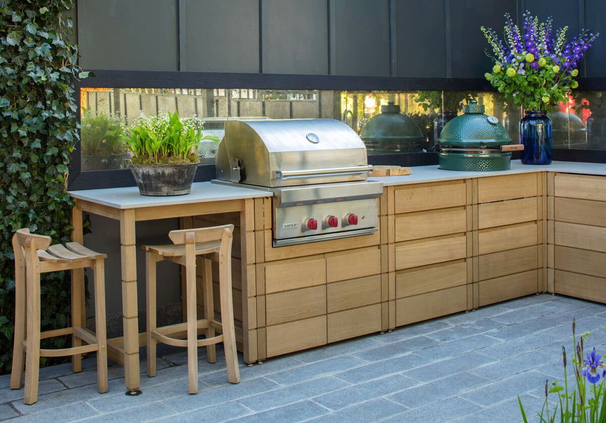 Outdoor kitchen with grill, big green egg, oak cabinets and counter